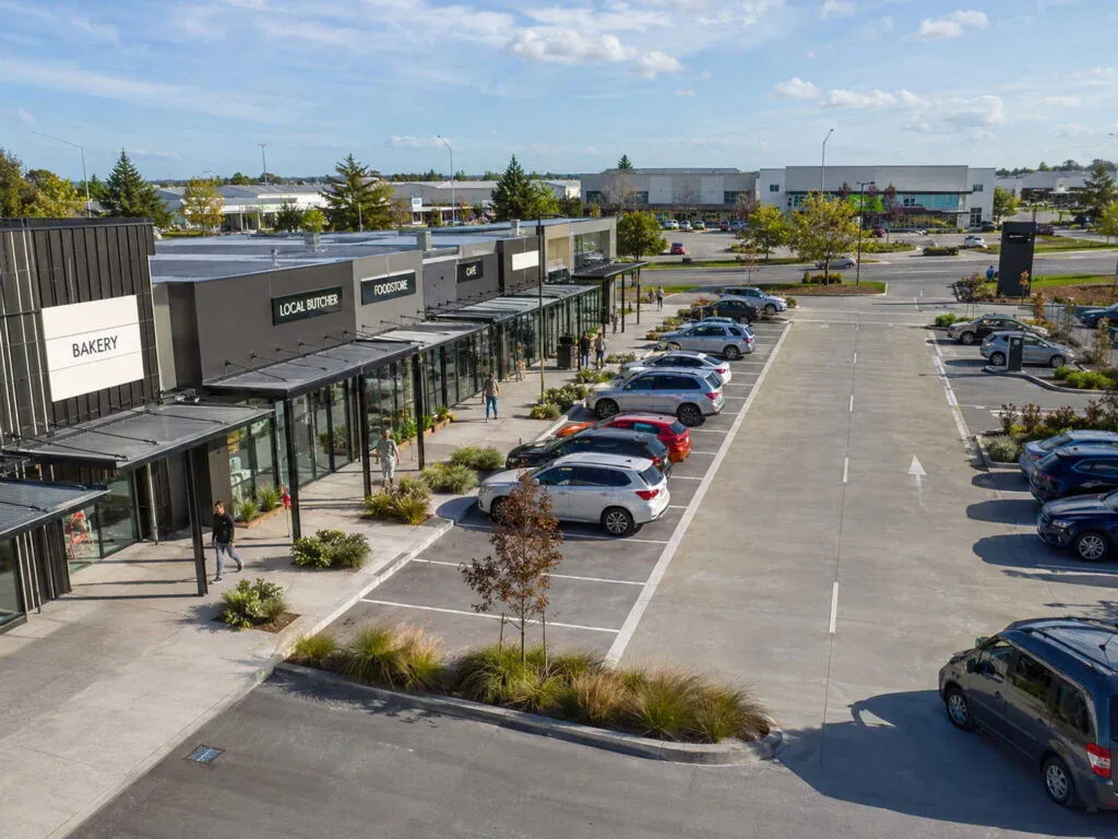 Retail centre car park with marked bays and landscaped islands